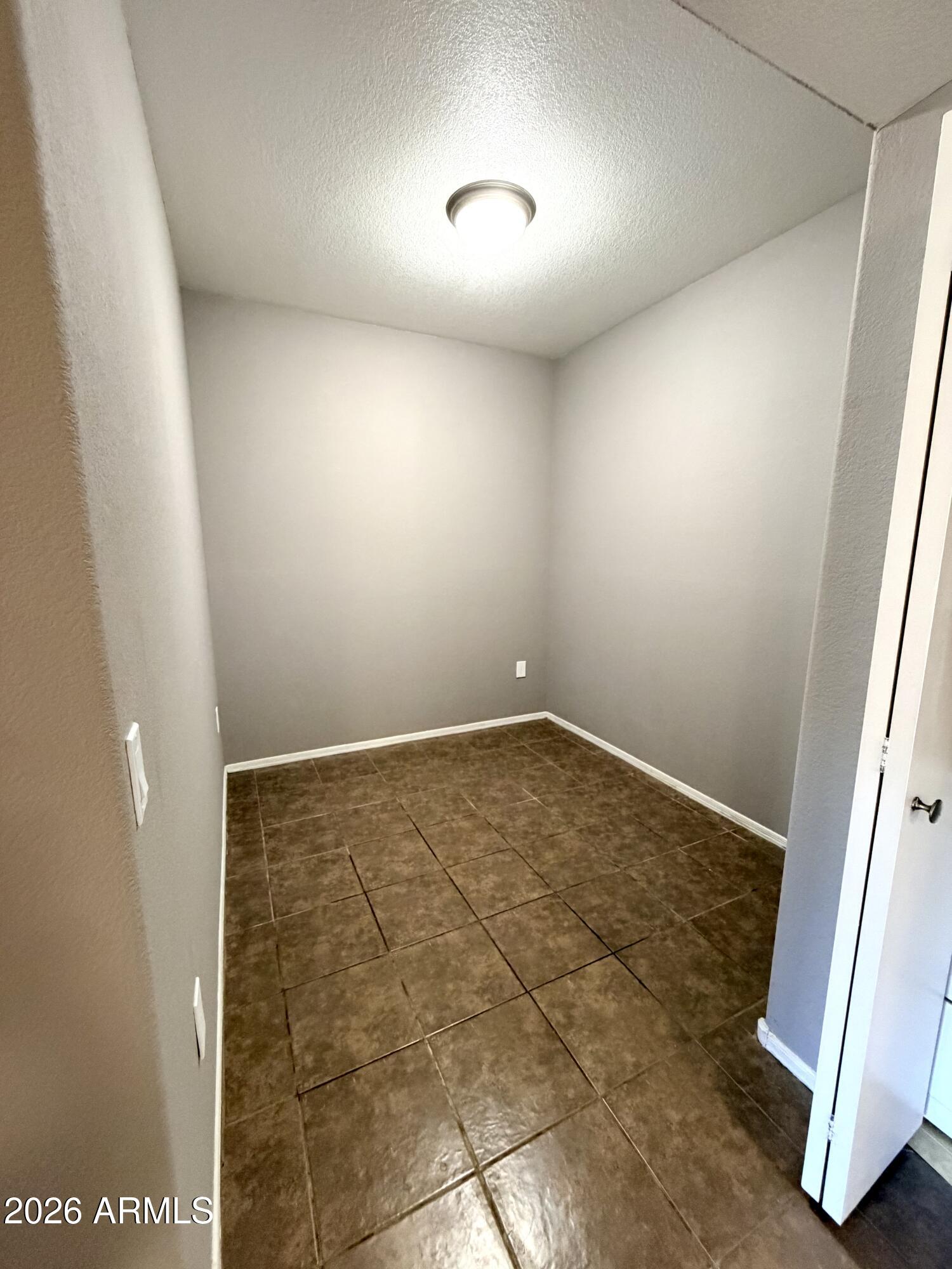 3434 East Baseline Road, Unit 165 Phoenix, AZ 85042 - Photo 5 of 12 an empty room with wooden floor and windows