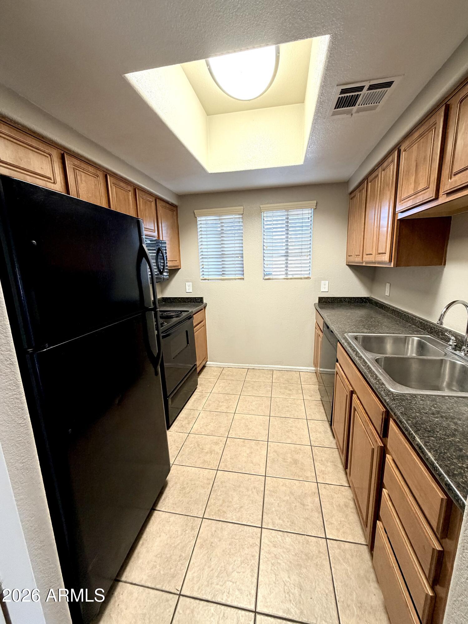 3434 East Baseline Road, Unit 165 Phoenix, AZ 85042 - Photo 6 of 12 a kitchen with a sink a stove and refrigerator