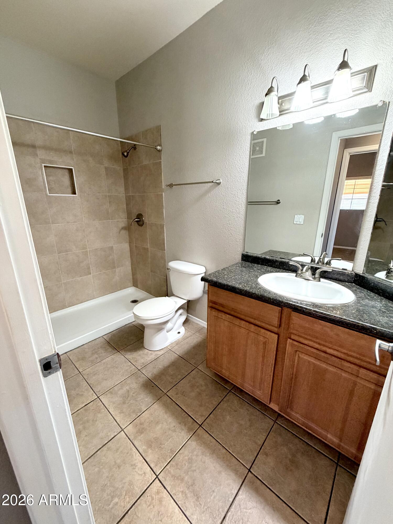 3434 East Baseline Road, Unit 165 Phoenix, AZ 85042 - Photo 10 of 12 a bathroom with a granite countertop sink toilet and shower