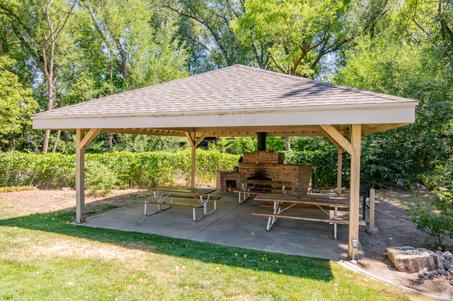 1221 Waterside Cove, Unit 11 Midvale, UT 84047 - Photo 19 of 23 Covered patio featuring a shingled roof and wood support beams