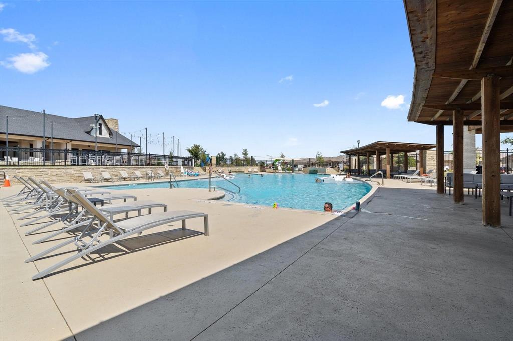 15932 Stableford Road Justin, TX 76247 - Photo 30 of 35 Community swimming pool with a large paved surround and multiple shaded lounge areas