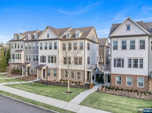a view of a big yard in front of a brick house
