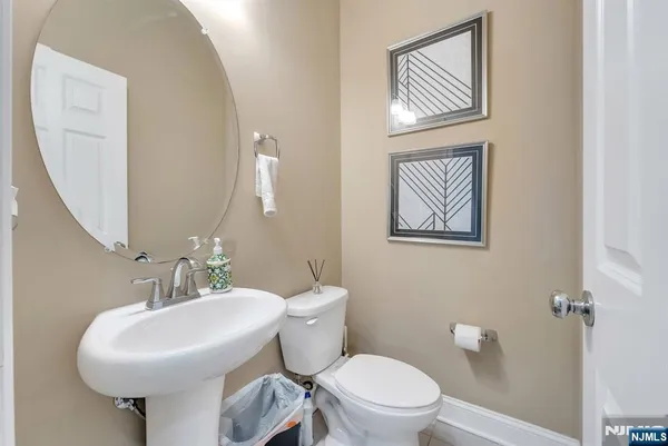 a bathroom with a toilet a sink and a mirror