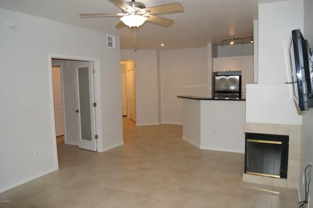 a view of a kitchen with a sink and a refrigerator