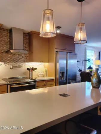 a kitchen with a sink and chandelier