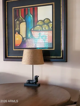 a room with painting on wall and a potted plant