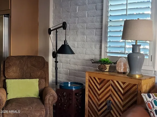 a living room with furniture and a lamp
