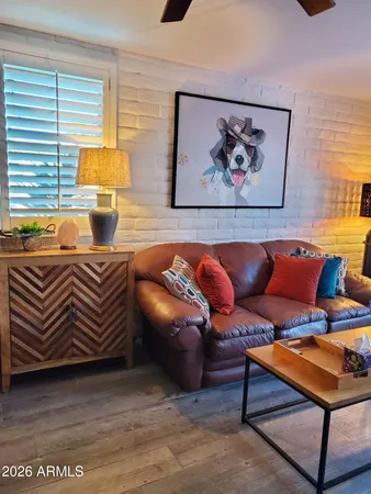 a living room with furniture a rug and a window