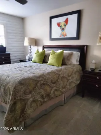 a bedroom with a bed and wall painting
