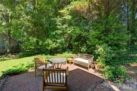 a view of a backyard with sitting area