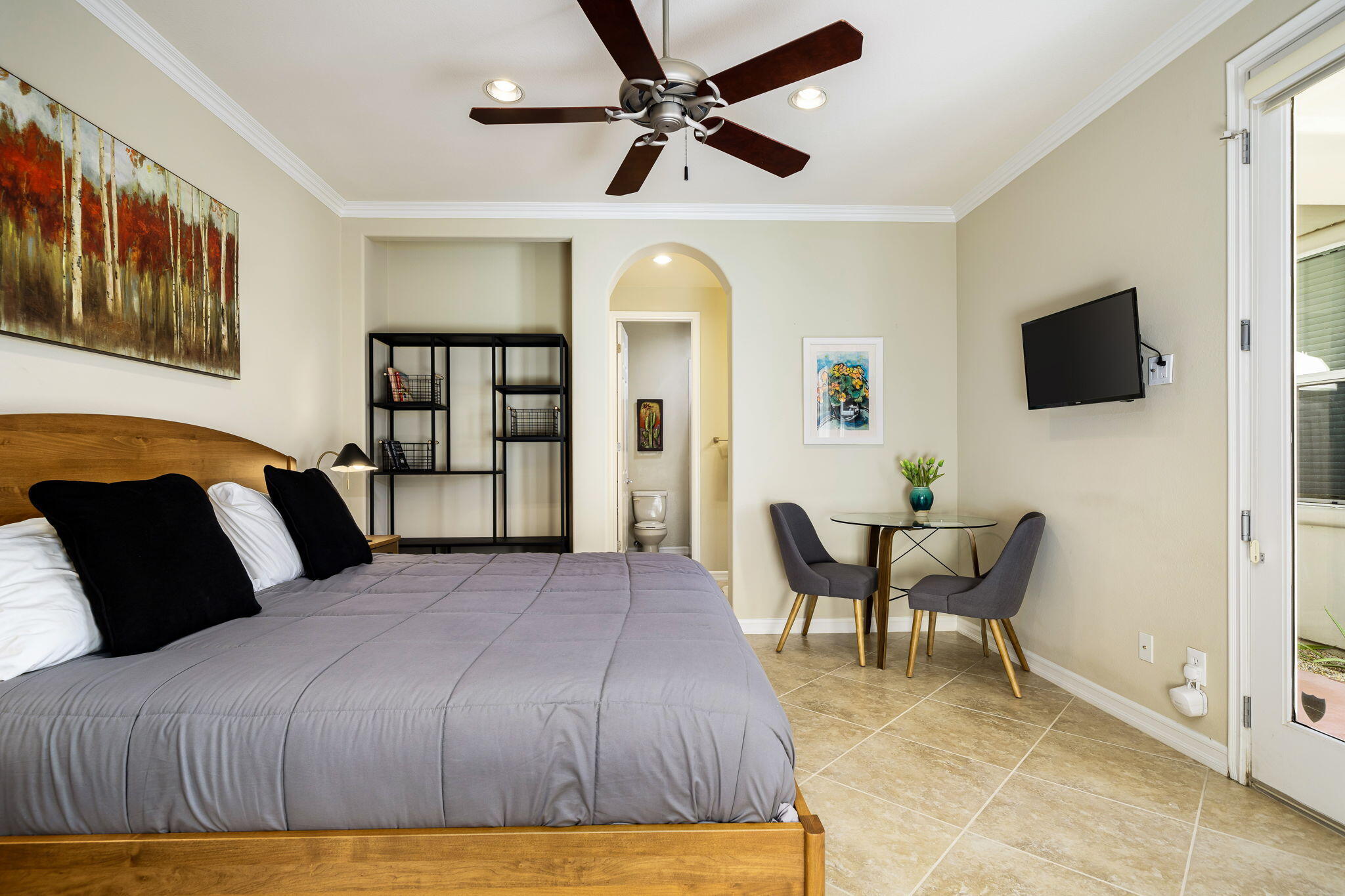 309 Loch Lomond Road Rancho Mirage, CA 92270 - Photo 13 of 27 a bedroom with a bed a chair and a flat screen tv
