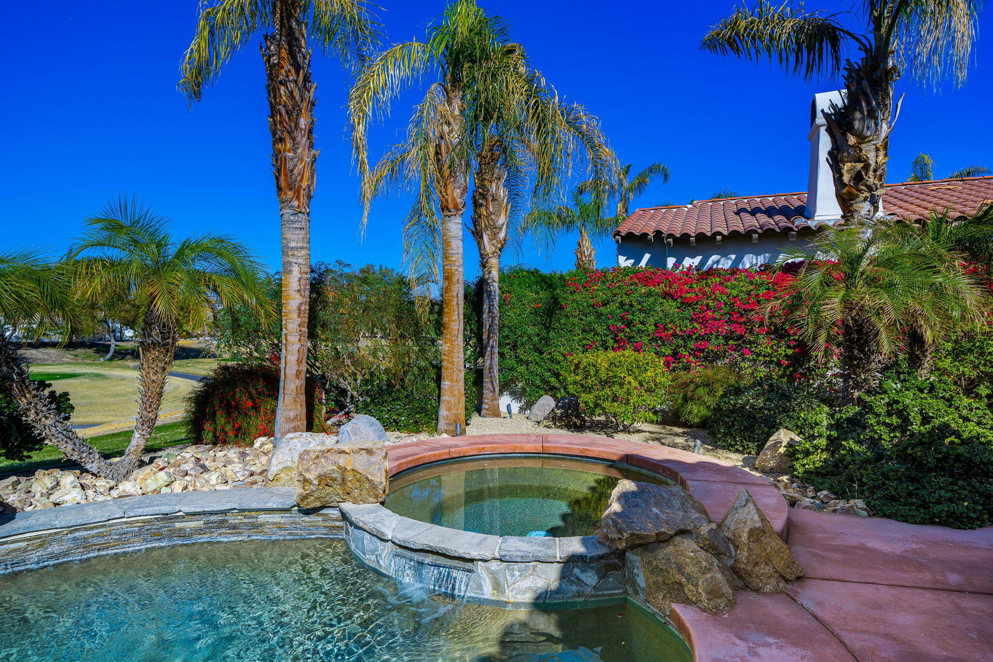 309 Loch Lomond Road Rancho Mirage, CA 92270 - Photo 16 of 27 a house with a yard and outdoor seating