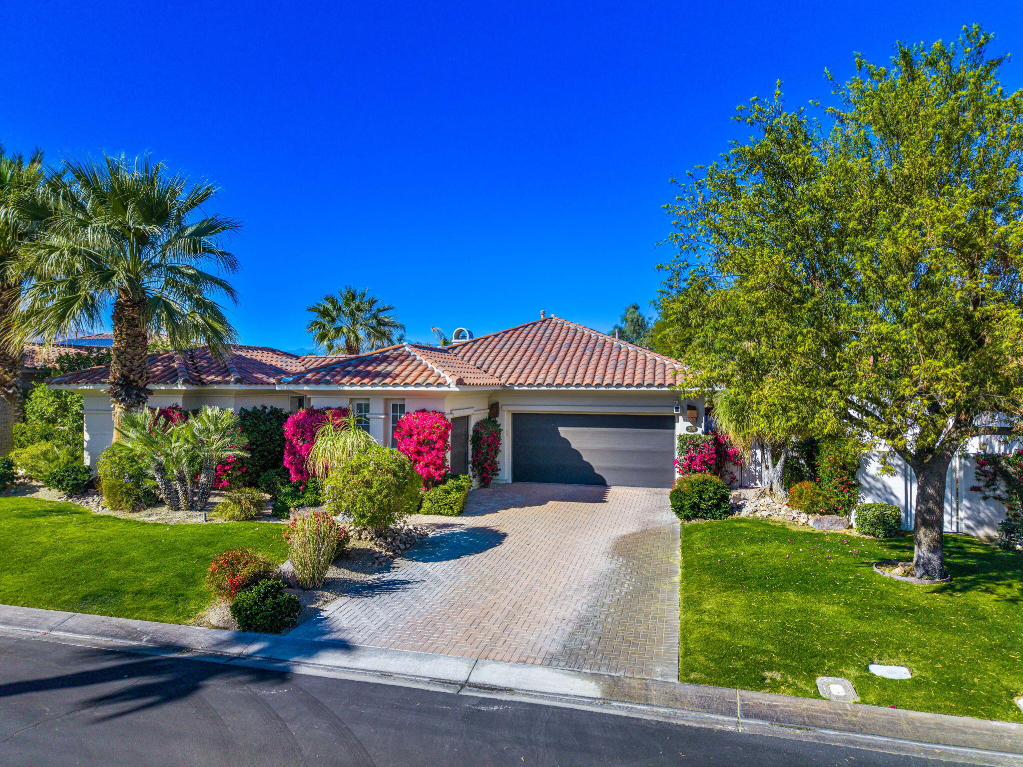 309 Loch Lomond Road Rancho Mirage, CA 92270 - Photo 2 of 27 a front view of a house with a yard