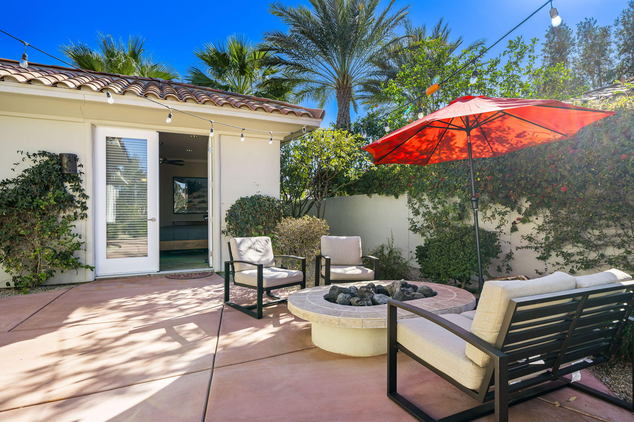 309 Loch Lomond Road Rancho Mirage, CA 92270 - Photo 21 of 27 a view of a patio with couches table and chairs and potted plants
