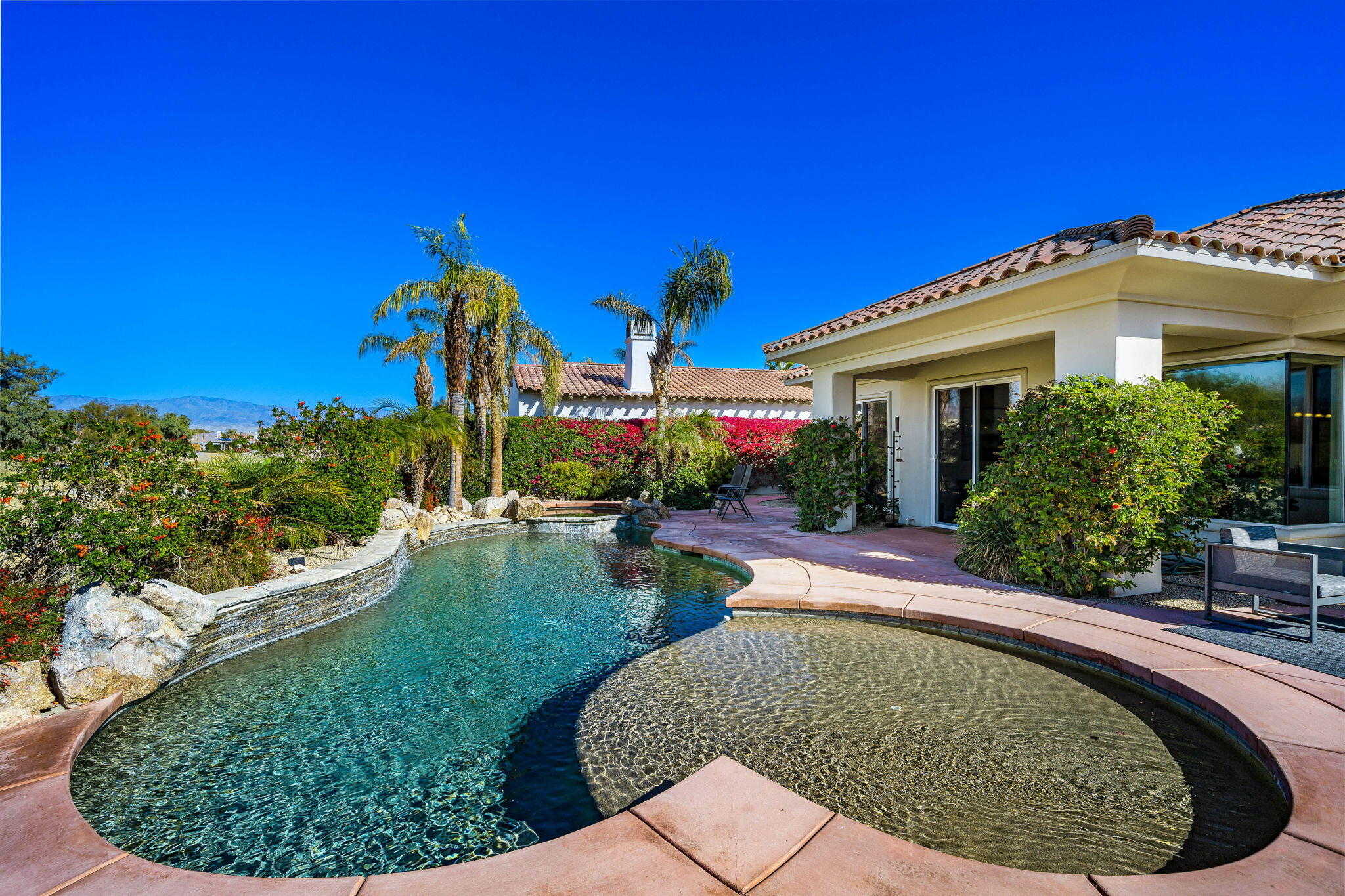 309 Loch Lomond Road Rancho Mirage, CA 92270 - Photo 24 of 27 a view of a house with pool fire pit and a yard