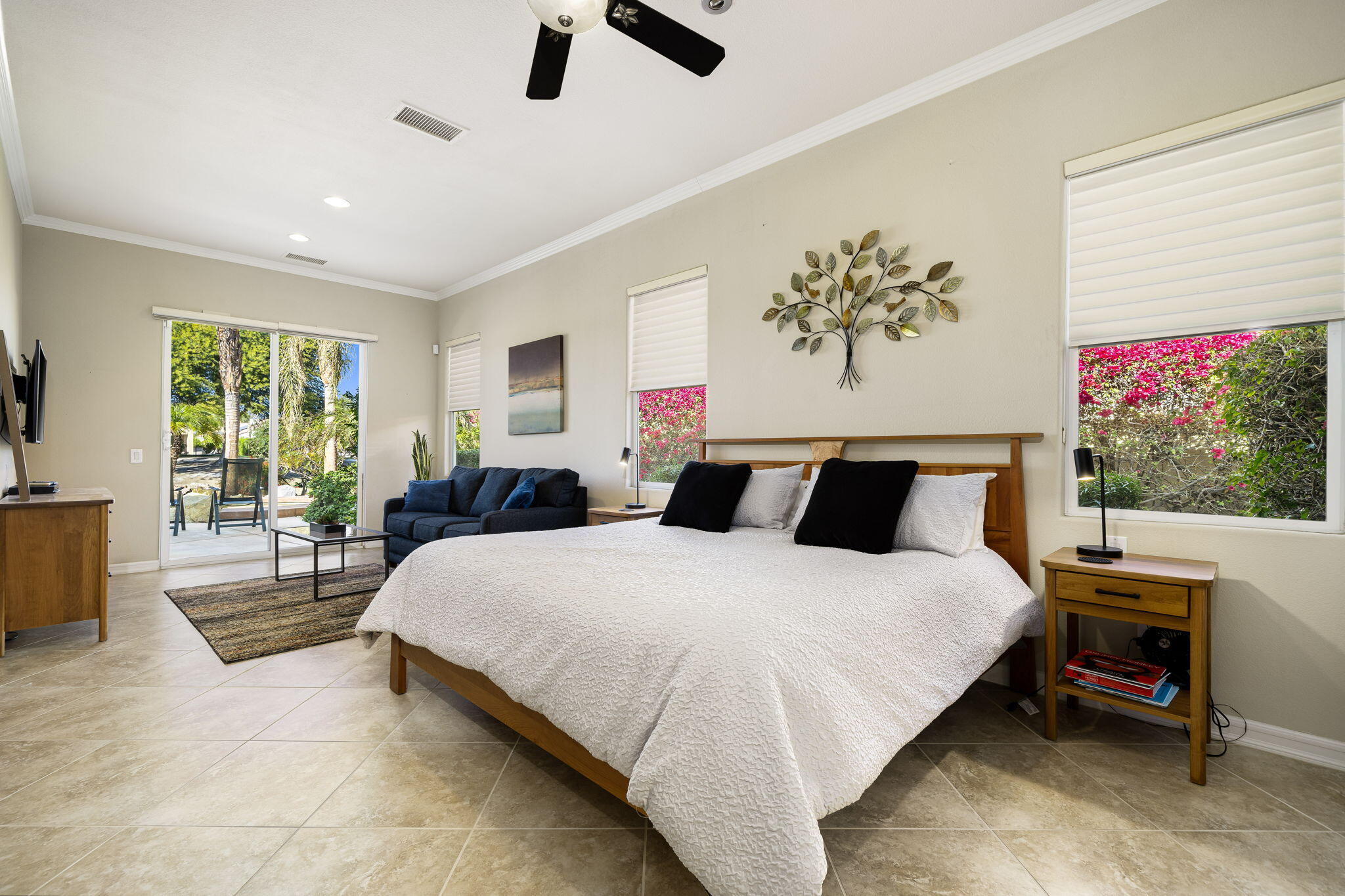 309 Loch Lomond Road Rancho Mirage, CA 92270 - Photo 10 of 27 a spacious bedroom with a large bed and a chandelier