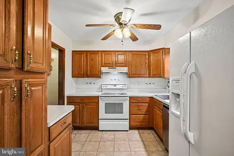 a kitchen with a stove sink and cabinets