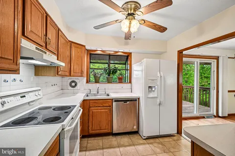 a kitchen with a stove a sink and a refrigerator