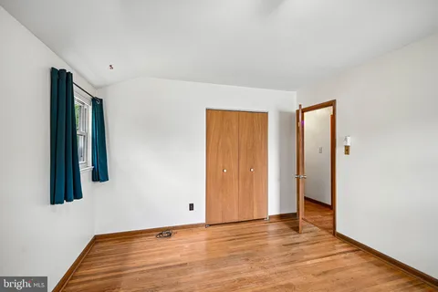 a view of a room with wooden floor and bathroom