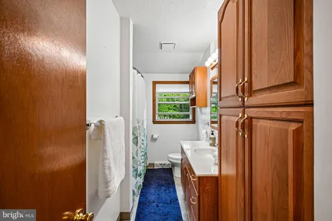 a view of a hallway with wooden floor and entryway