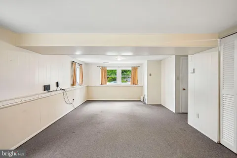 a view of a kitchen with an empty room and window