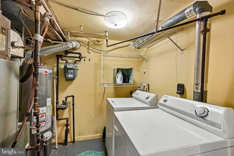 a utility room with multiple dryer and washer