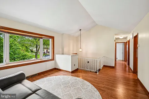 a view of a room with furniture and wooden floor