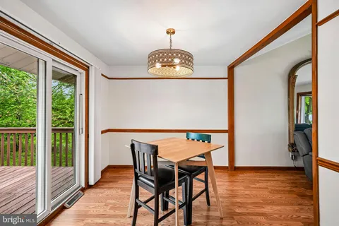 a view of a dining room with furniture wooden floor and a chandelier