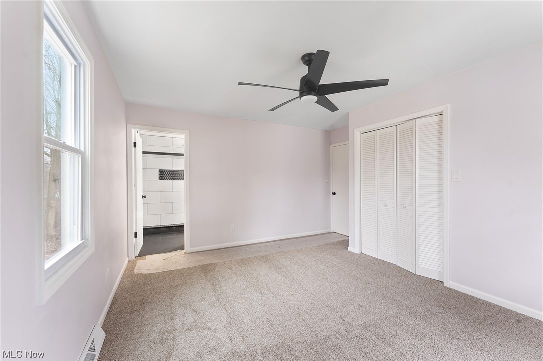 1707 Brookfield Road Hubbard, OH 44425 - Photo 17 of 30 Unfurnished bedroom featuring multiple windows, light colored carpet, and ceiling fan