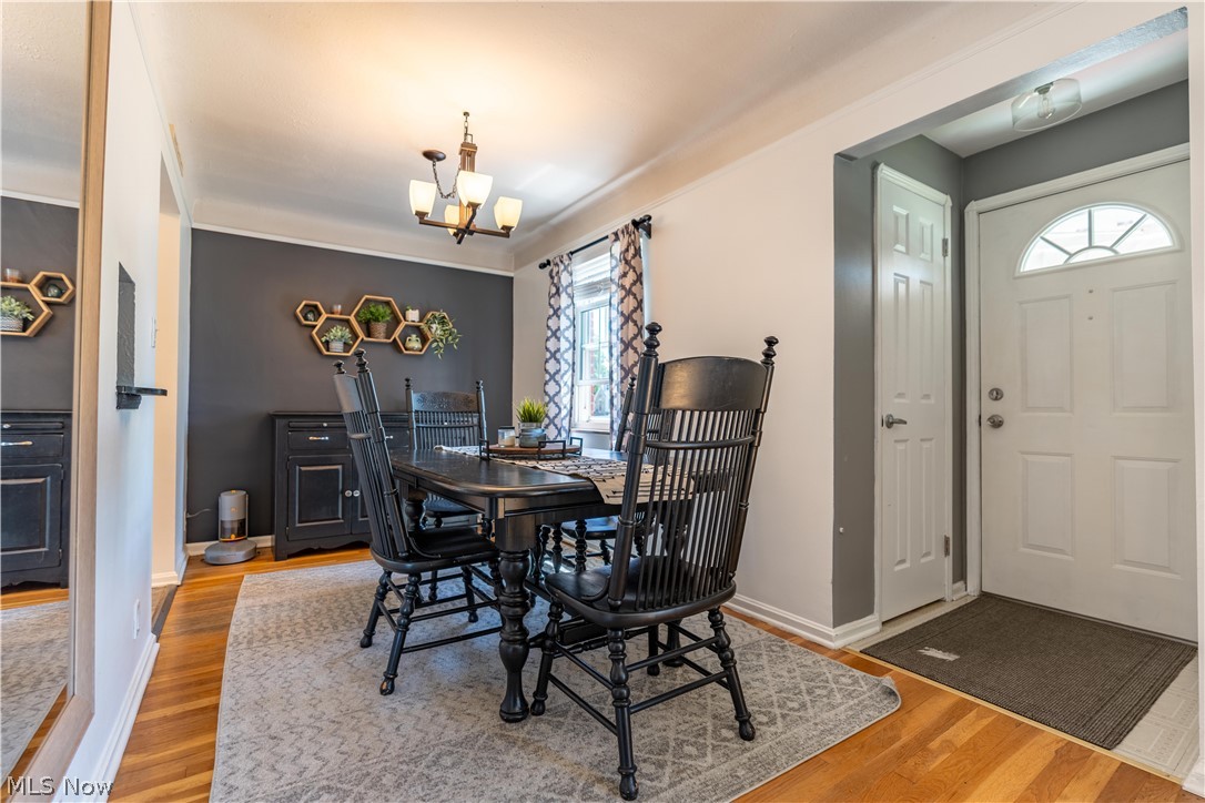 8320 Ackley Road Parma, OH 44129 - Photo 15 of 36 Dining area featuring an inviting chandelier and wood-type flooring