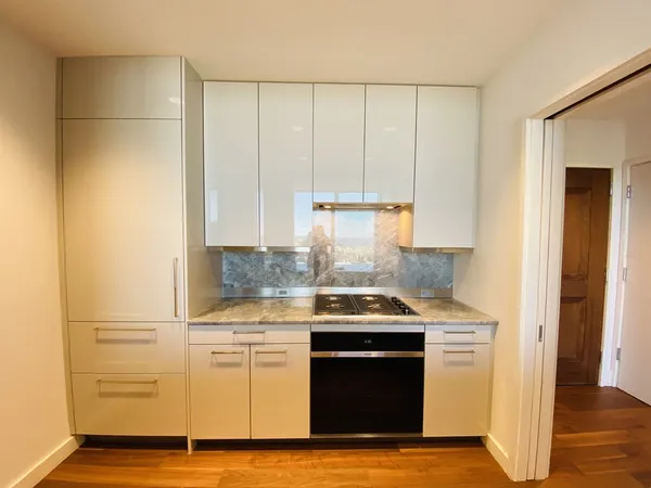 a kitchen with stainless steel appliances granite countertop a sink stove and cabinets
