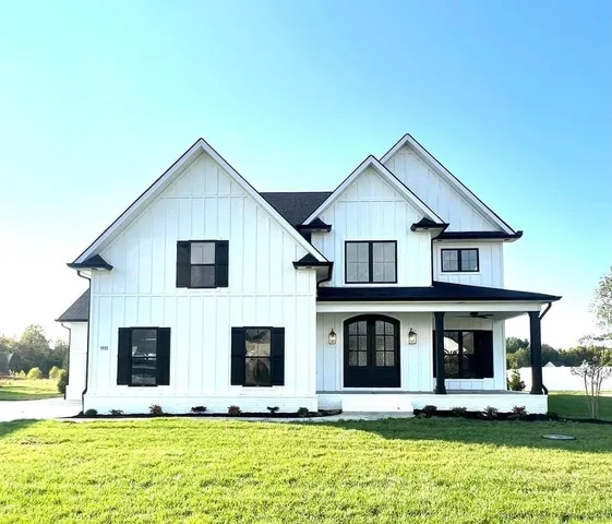 a front view of a house with garage and yard