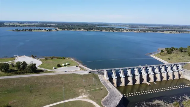 a view of field with trees in background