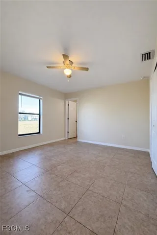 an empty room with a empty space and a ceiling fan