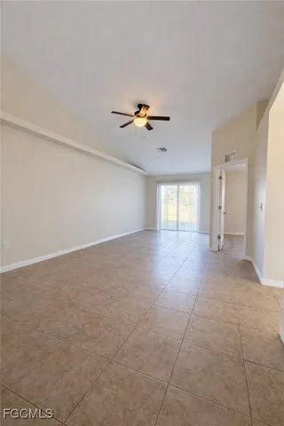 a view of an empty room with a ceiling fan