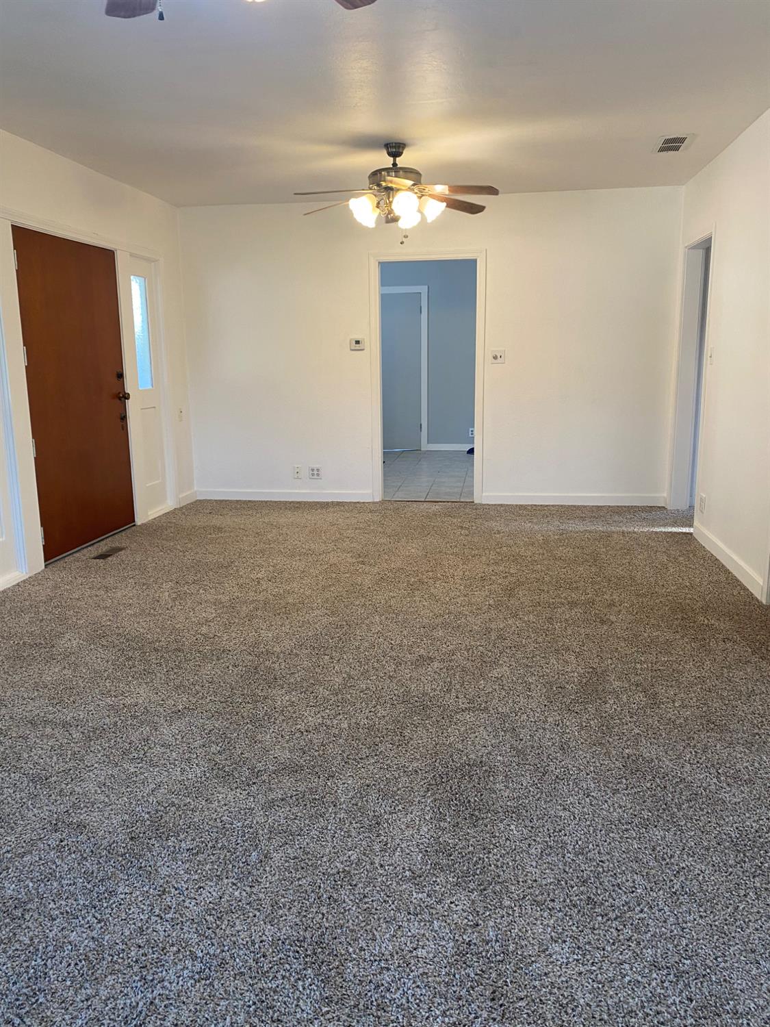 947 West Friesen Avenue Reedley, CA 93654 - Photo 2 of 34 a view of an empty room with a chandelier fan
