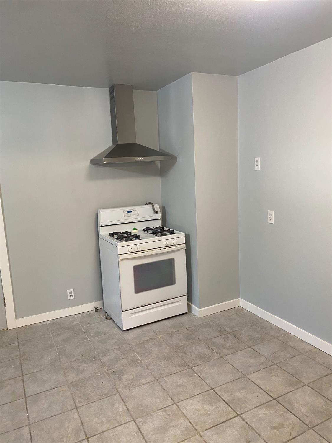 947 West Friesen Avenue Reedley, CA 93654 - Photo 22 of 34 a kitchen with white cabinets and white appliances