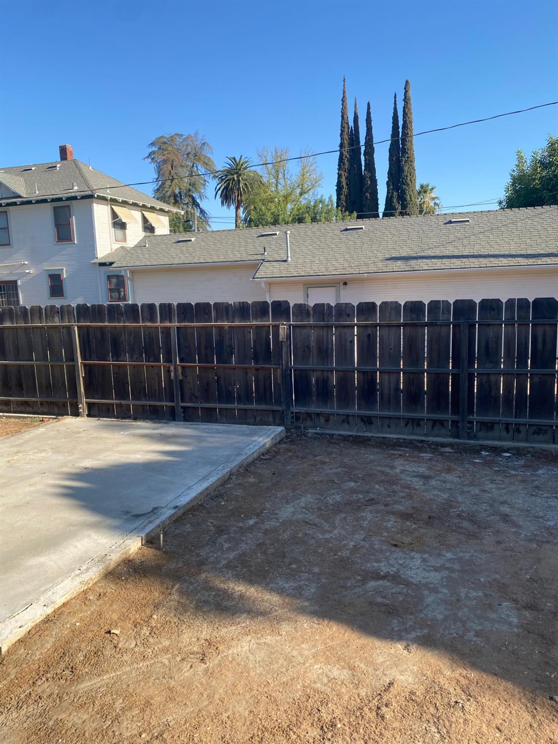 947 West Friesen Avenue Reedley, CA 93654 - Photo 28 of 34 a view of a white house with a yard and potted plants