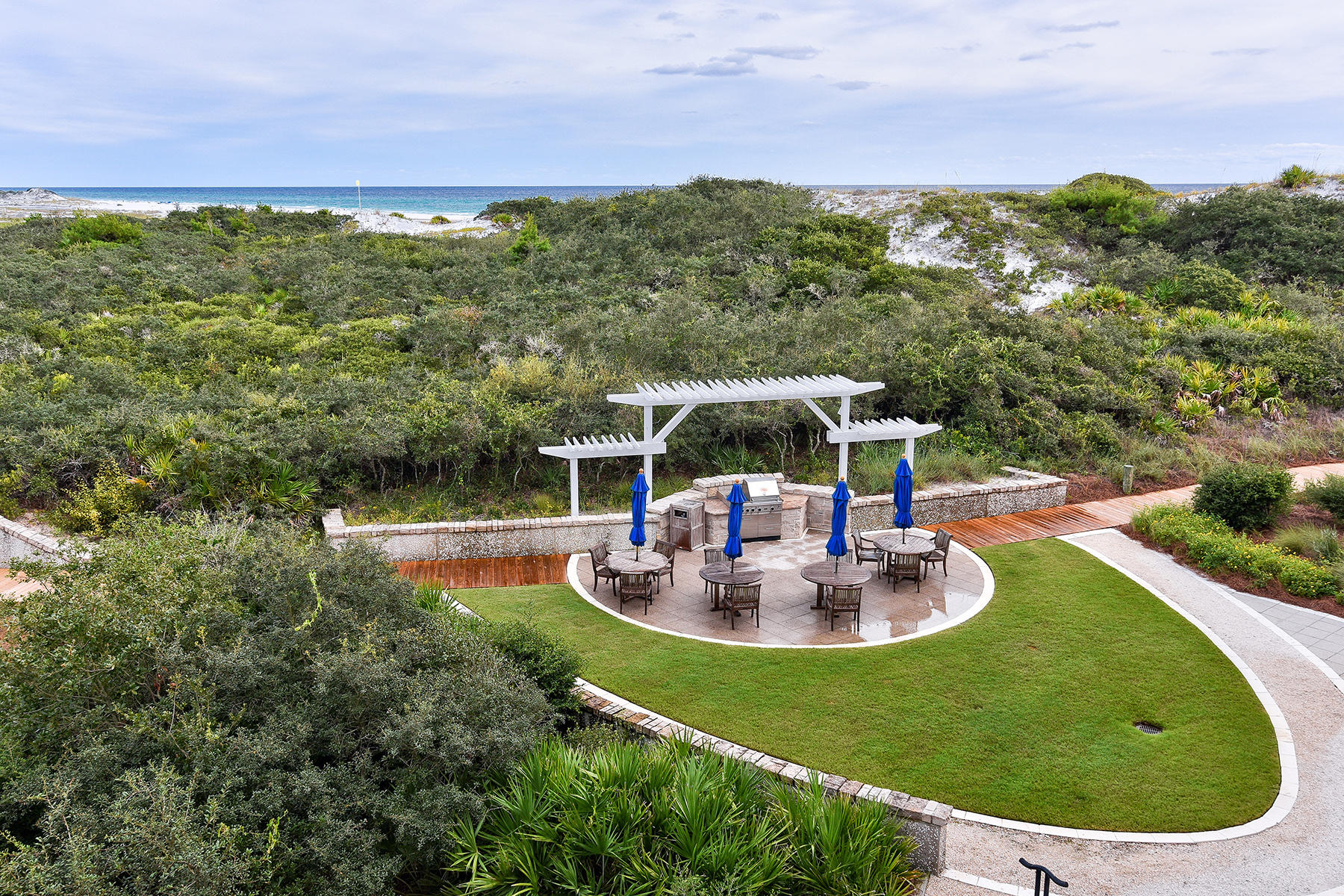 99 Compass Point Way, Unit 303 Watersound, FL 32461 - Photo 16 of 24 a view of a swimming pool with a table and chairs