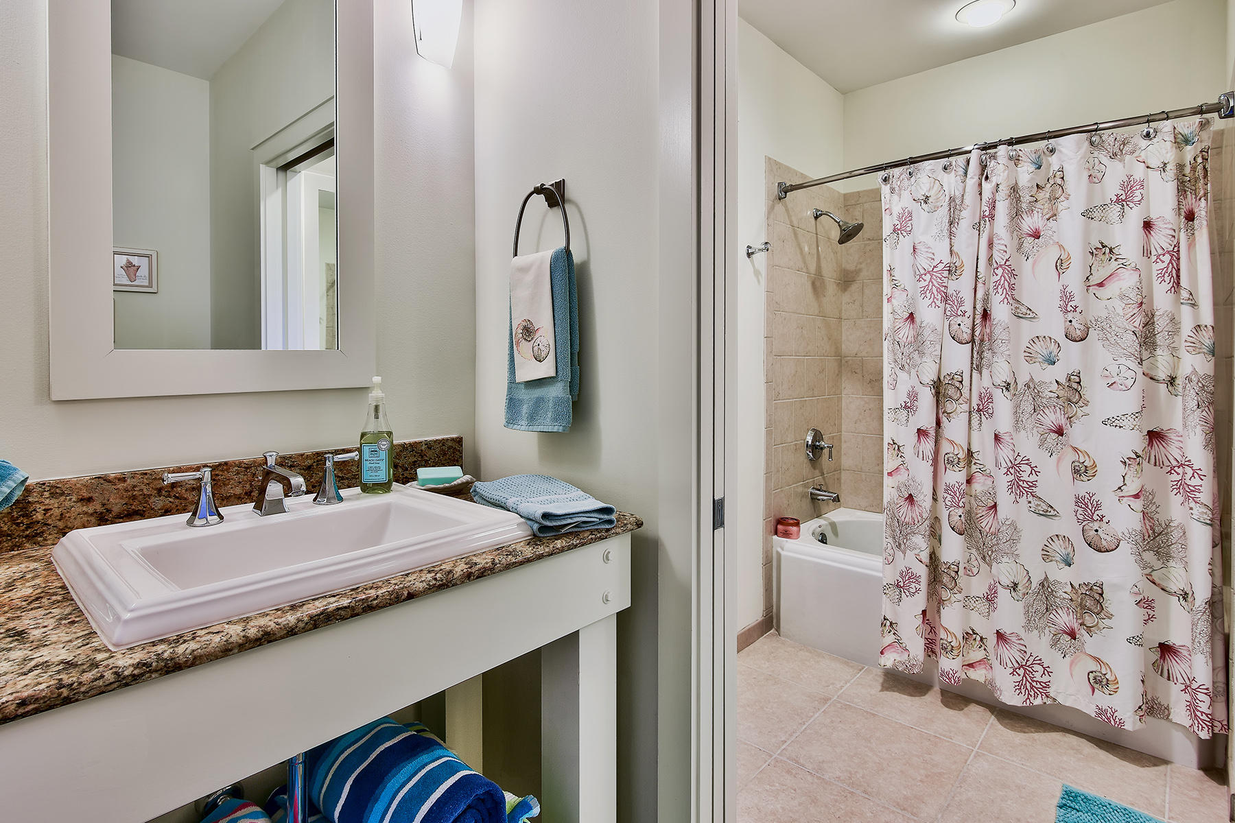 99 Compass Point Way, Unit 303 Watersound, FL 32461 - Photo 19 of 24 a bathroom with a granite countertop sink and a mirror