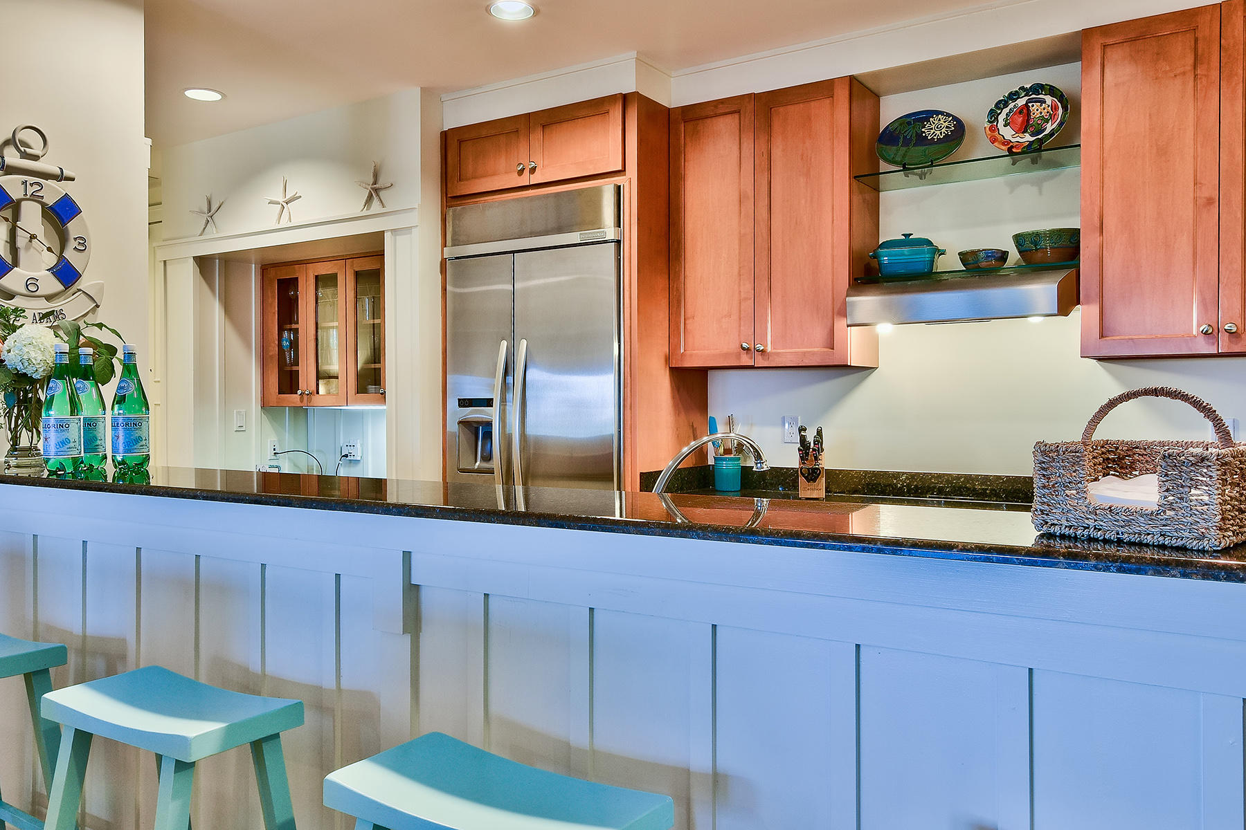 99 Compass Point Way, Unit 303 Watersound, FL 32461 - Photo 5 of 24 a kitchen with stainless steel appliances a refrigerator a sink a stove and wooden cabinets