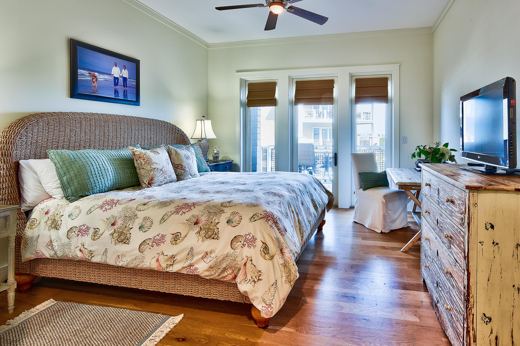 99 Compass Point Way, Unit 303 Watersound, FL 32461 - Photo 8 of 24 a bedroom with a large bed and a flat tv screen on dresser
