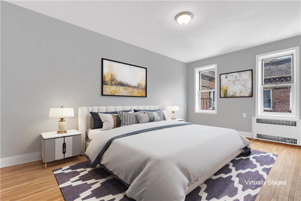 9281 Shore Road, Unit 602 Brooklyn, NY 11209 - Photo 11 of 17 a spacious bedroom with a bed and wooden floor