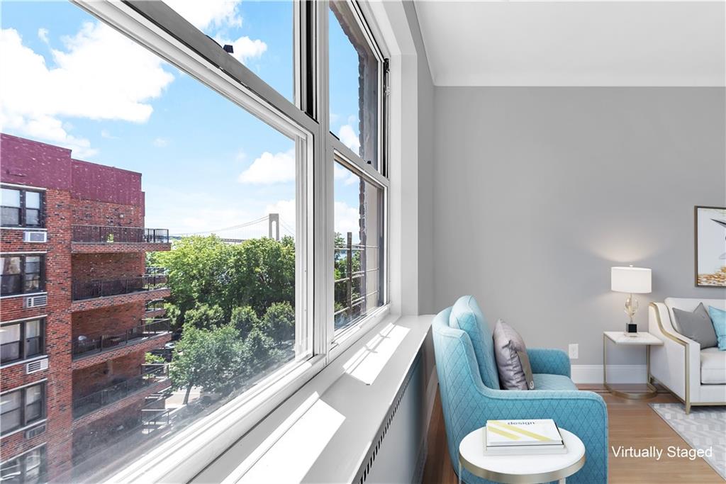 9281 Shore Road, Unit 602 Brooklyn, NY 11209 - Photo 3 of 17 a living room with furniture and a floor to ceiling window