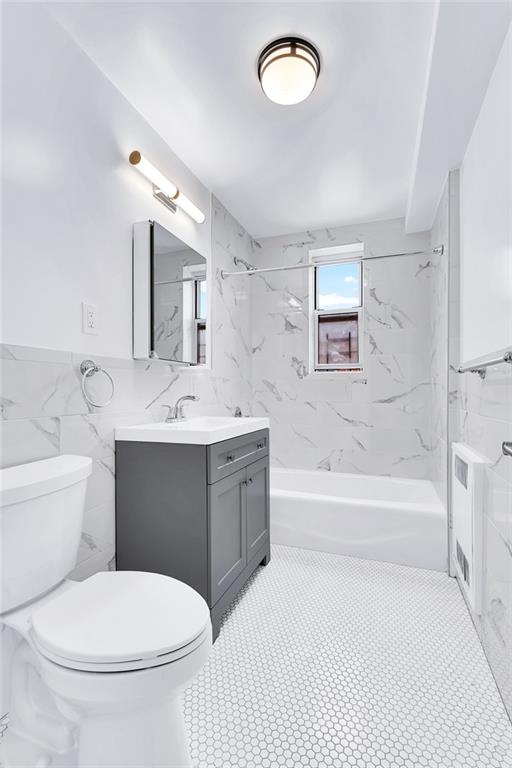 9281 Shore Road, Unit 602 Brooklyn, NY 11209 - Photo 8 of 17 a bathroom with a sink a toilet and a bathtub