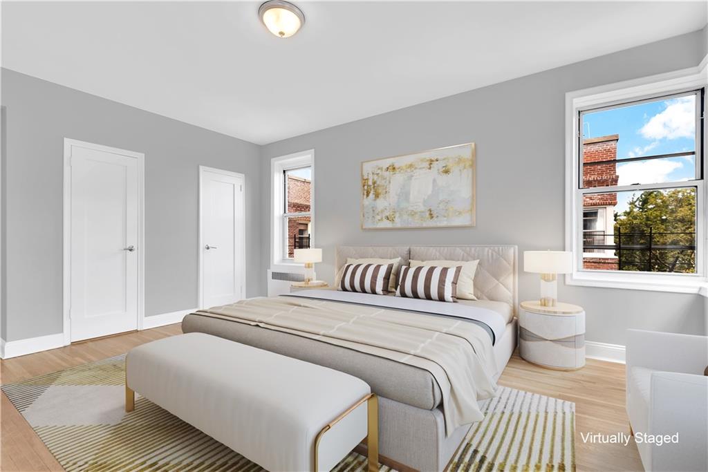 9281 Shore Road, Unit 602 Brooklyn, NY 11209 - Photo 10 of 17 a bedroom with a bed and a large window