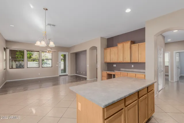 a kitchen with stainless steel appliances granite countertop a stove and a sink with cabinets