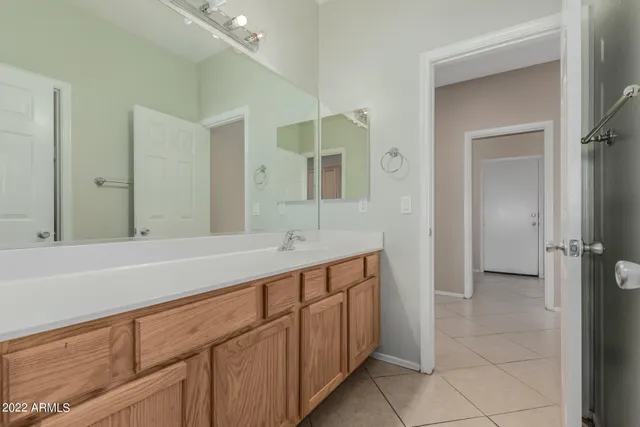 a spacious bathroom with a sink and a mirror