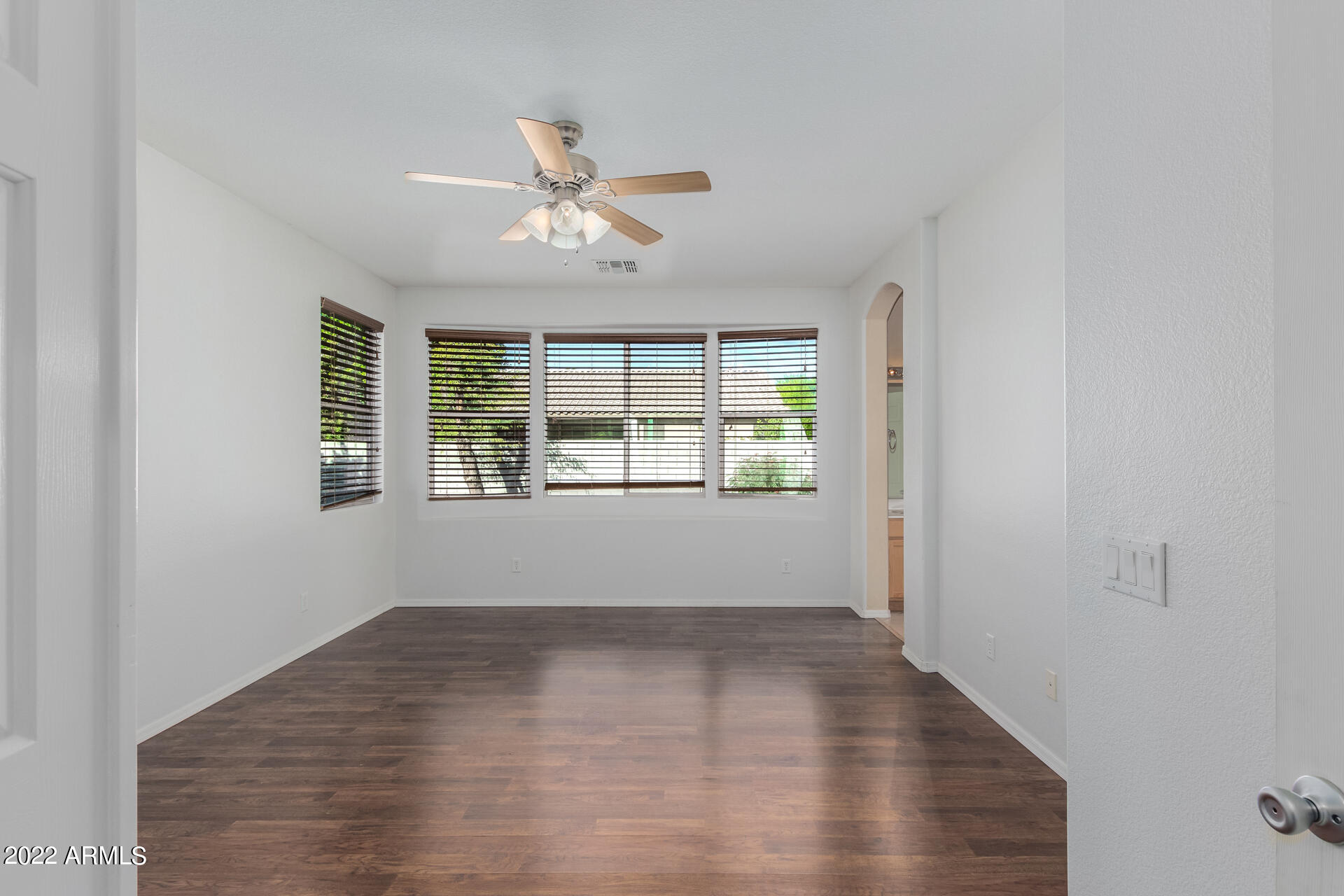 14440 West Redfield Road Surprise, AZ 85379 - Photo 17 of 36 a view of empty room with wooden floor and fan