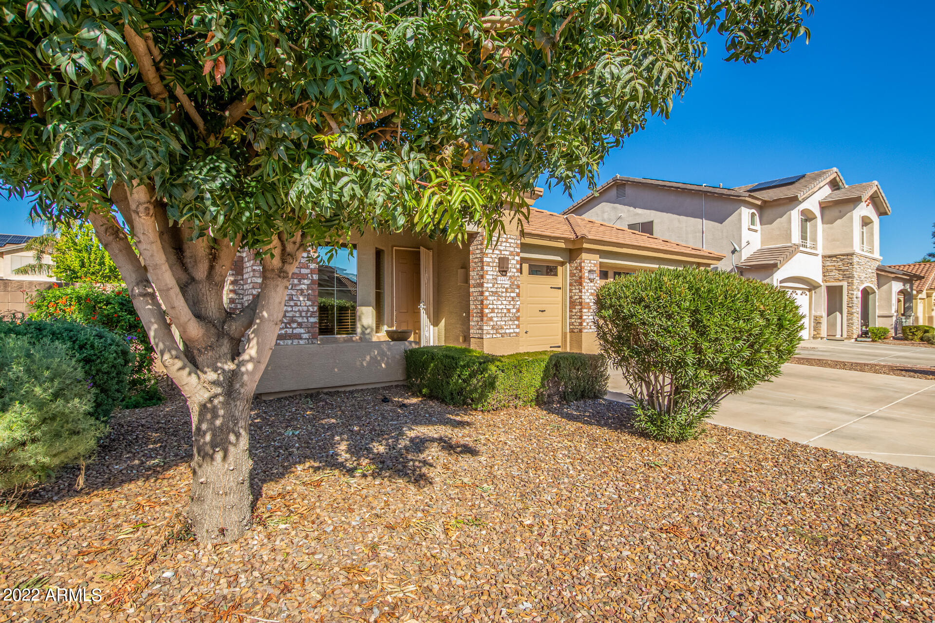 14440 West Redfield Road Surprise, AZ 85379 - Photo 23 of 36 a front view of a house with a yard and garage